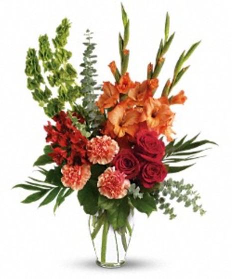 Sympathy bouquet of red roses, alstroemeria, gladioli and more in a Ming urn. 