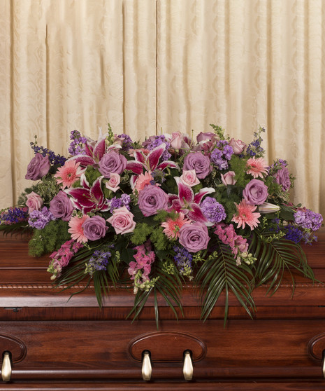 Casket spray of pastel roses, gerbera daisies, lilies and more. 