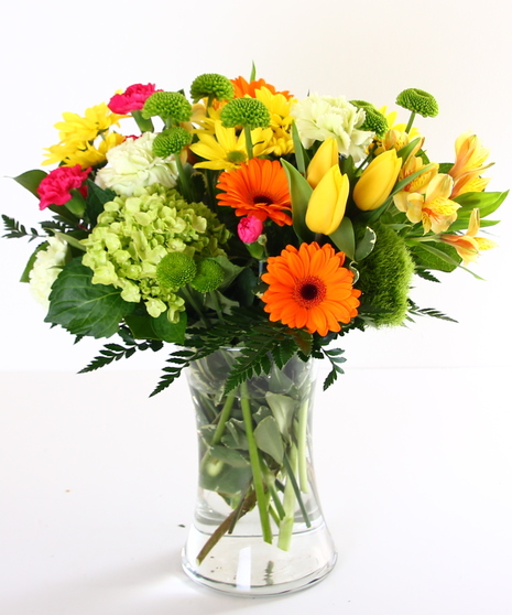 Bright spring flowers in a glass vase.