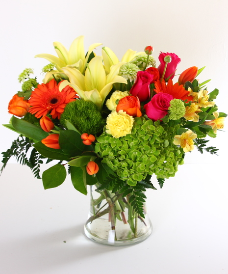 Bright spring flowers in a glass vase.