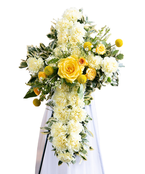 White floral cross white red flower accents and greenery displayed on an easel. 