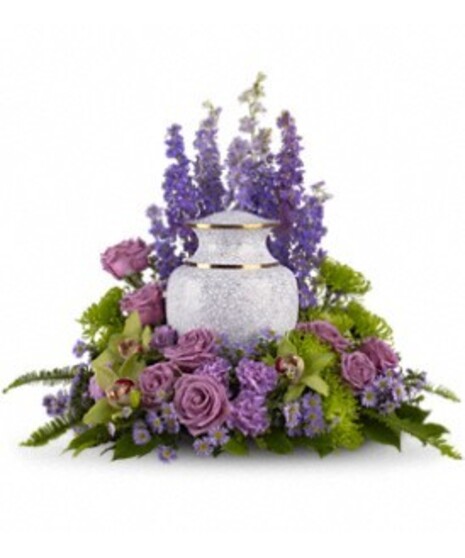 Sympathy display of lavender and green flowers to surround an urn. 