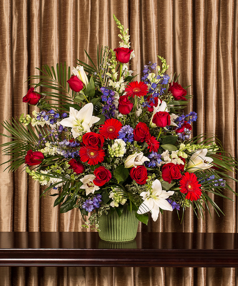 Patriotic arrangement of red, white and blue flowers. 