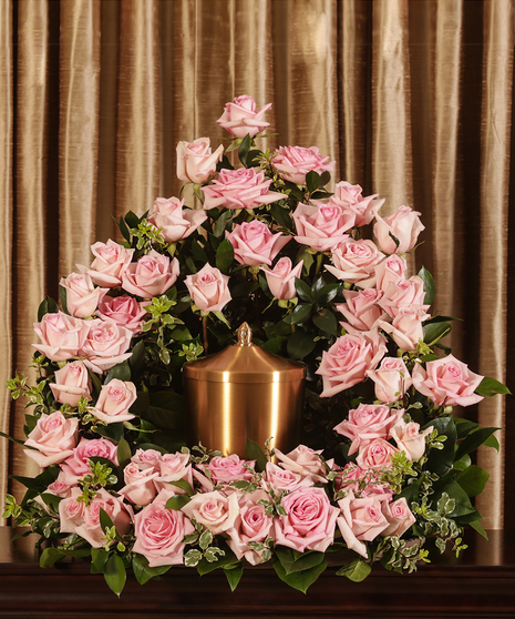 Sympathy display of pink roses to surround an urn. 