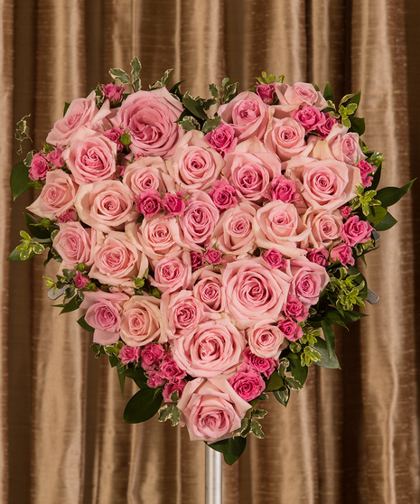 Sympathy heart of pink roses and greenery. 