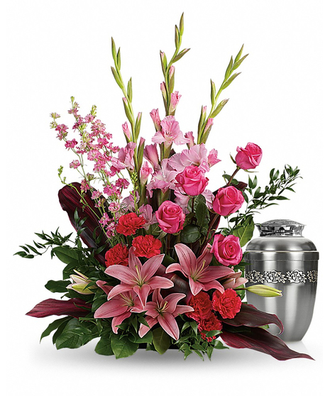 Sympathy arrangement of hot pink and pink flowers to surround an urn. 